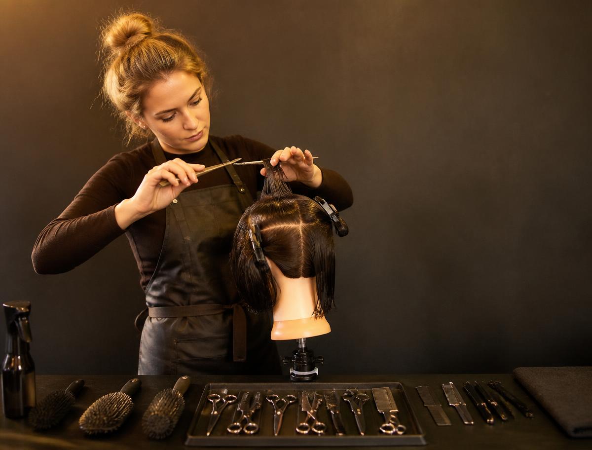 Stylist practising cutting technique during a training session